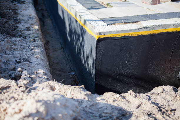 Professional Basement Waterproofing technician working in Fayetteville, OH